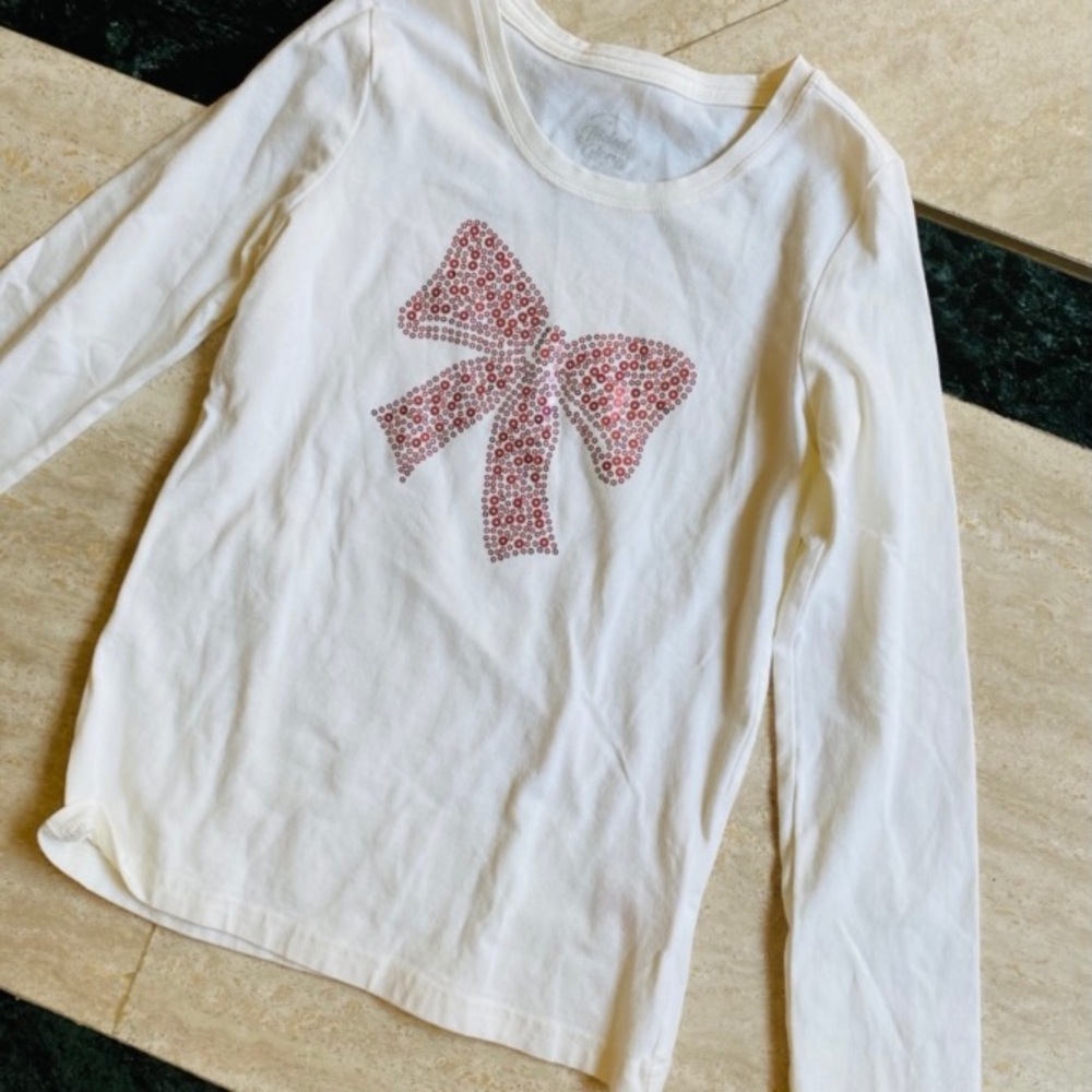 White long sleeved top with pink sequin bow